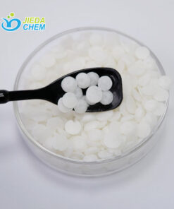 Glyceryl Stearate (And) PEG-100 Stearate scooped out from the transparent small bowl with a small black spoon