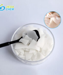 The White Flake Cetearyl Glucoside/Sorbitan Olivate on the black spoon