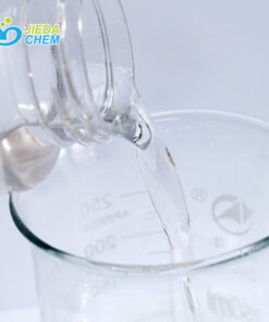 The transparent liquid Cetyl Ethylhexanoate contained in the small bottle is being poured into the beaker